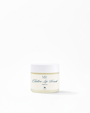 A small white jar of M.D. Blend Lip Scrub in Vanilla scent, set against a solid white background with a soft shadow.