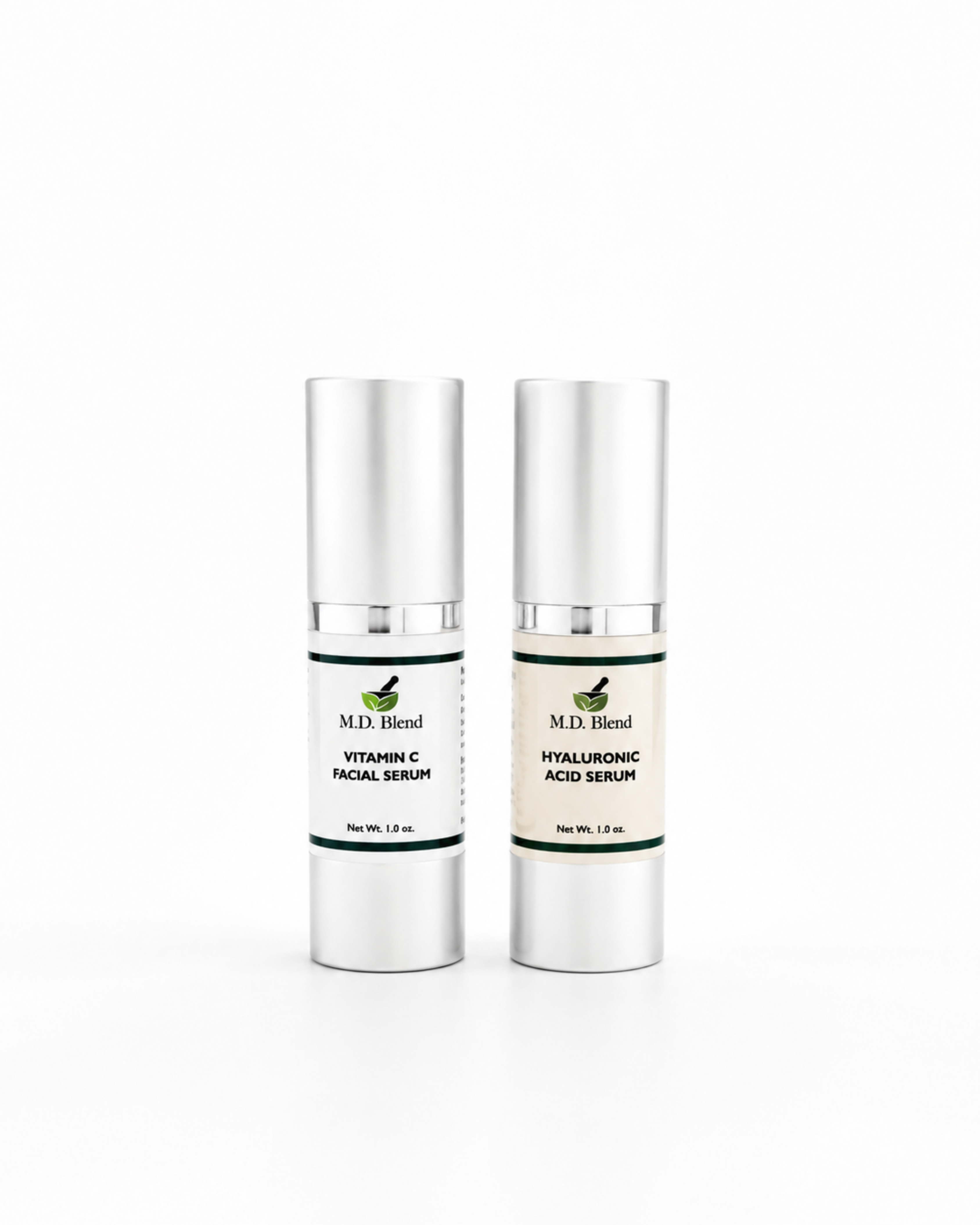 Two M.D. Blend skincare serum bottles featuring Vitamin C Facial Serum and Hyaluronic Acid Serum displayed side by side on a clean white studio background with soft natural shadows.